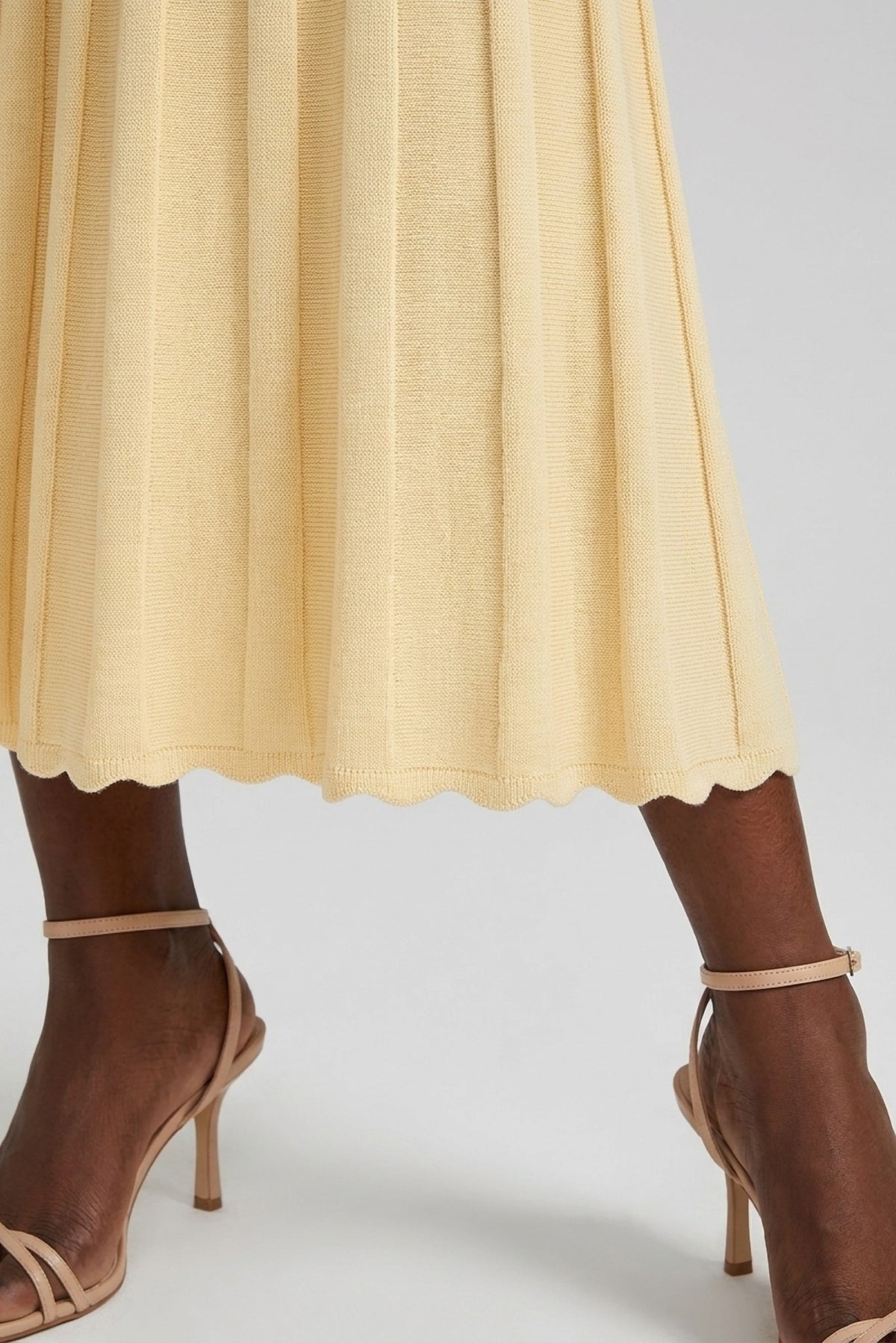 Henriette Knit Peplum Cardigan and Pleated Skirt Set close-up of the pleated skirt hem - Akalia